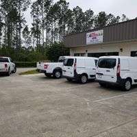 Atec Air & Heating service van fleet parked outside the company's Bunnell shop