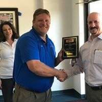 An Atec Air & Heating team member being presented an award at a local event